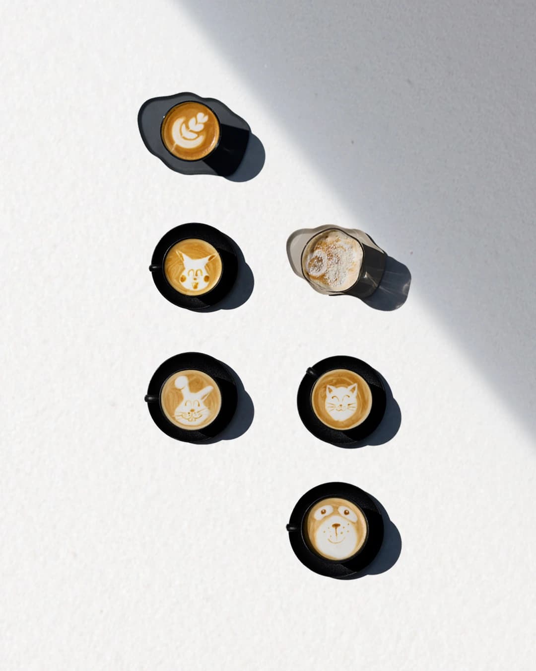 1407 coffee cups with animal character latte art - social media styled flatlay